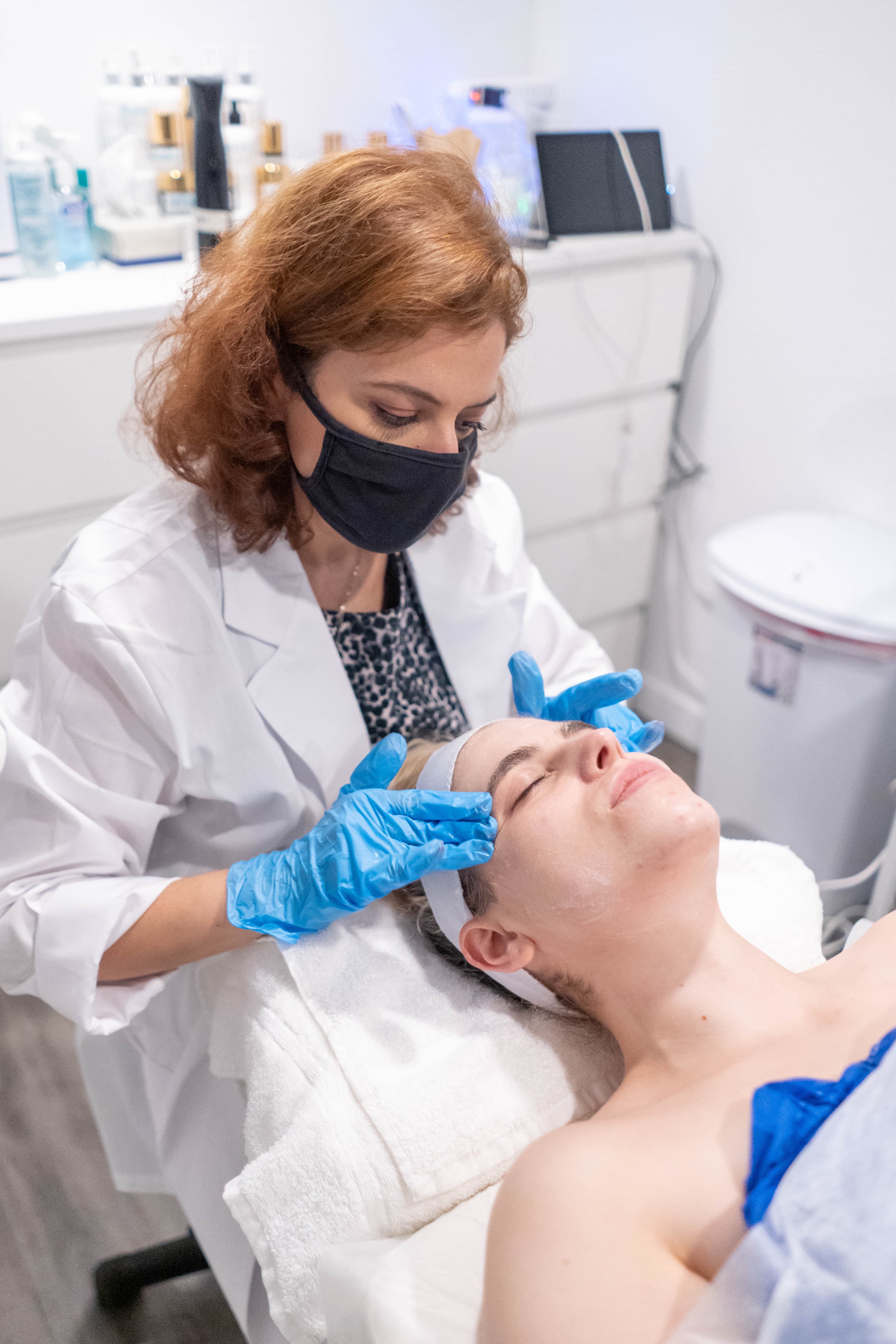An Aionios esthetician performing a customized facial